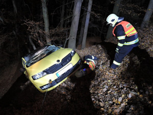 Těžká technika musela večer vyprošťovat auto z lesa. Řidič skončil v nemocnici