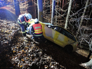 Těžká technika musela večer vyprošťovat auto z lesa. Řidič skončil v nemocnici
