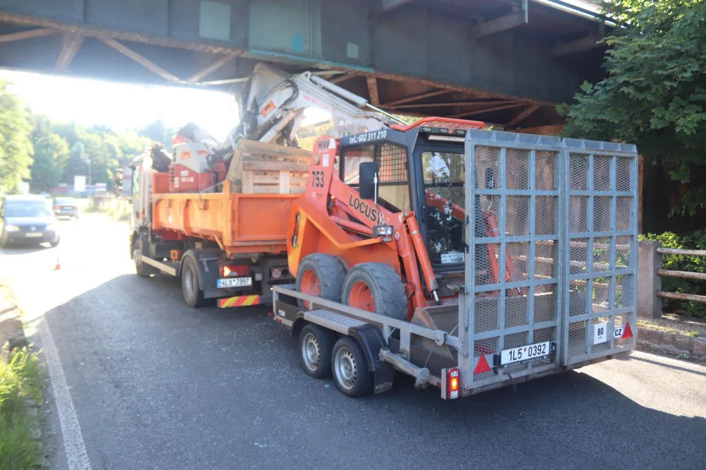 Nákladní auto převážející bagr uvízlo pod železničním mostem. Na hodinu se zastavil provoz na železnici