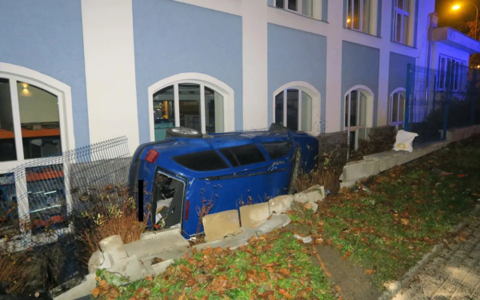 Mladý řidič nezvládl jízdu a havaroval. Prorazil plot a auto skončilo na boku opřené o dům